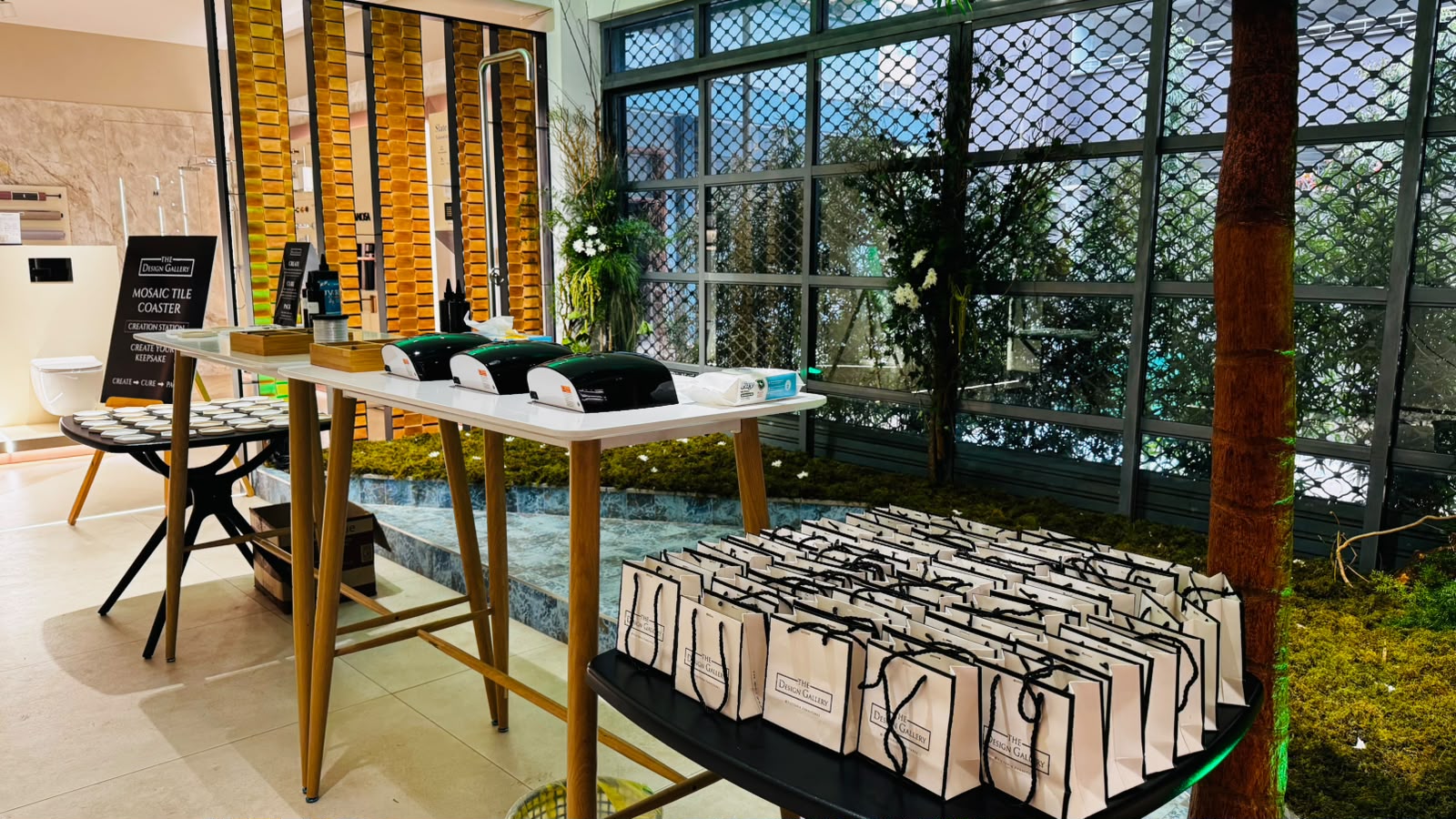 Mosaic tile coaster creation station with branded takeaway gift bags for guests