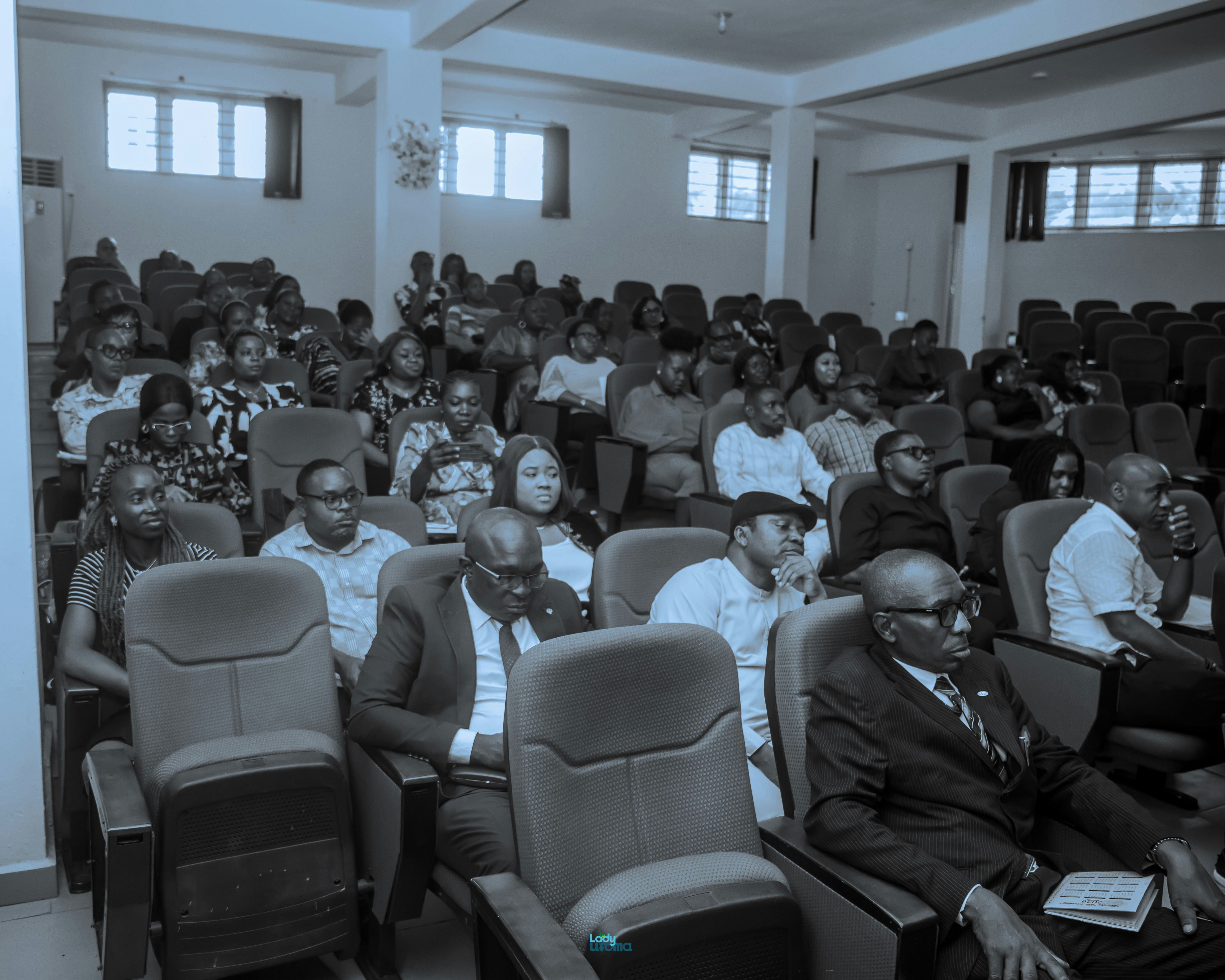 Representative image of delegates seated in an auditorium during a conference session