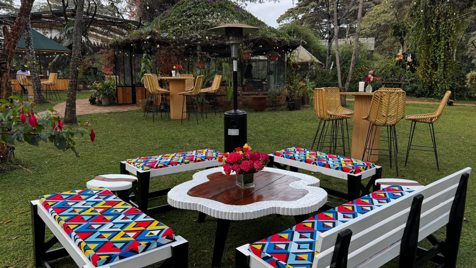 Garden lounge seating with colorful African-print upholstery around a mosaic table