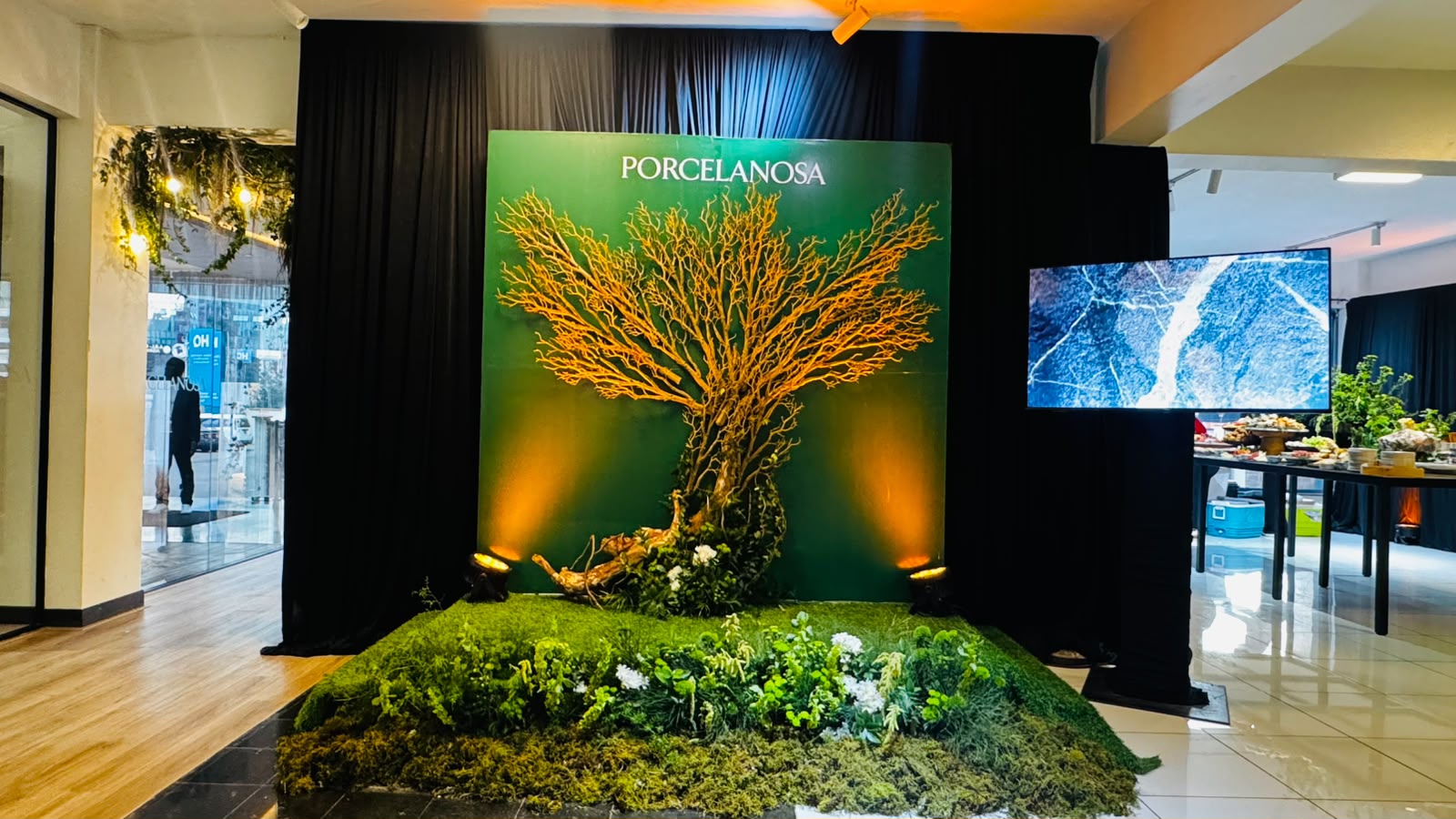 Sculptural tree branch installation on a moss base for a Porcelanosa brand activation